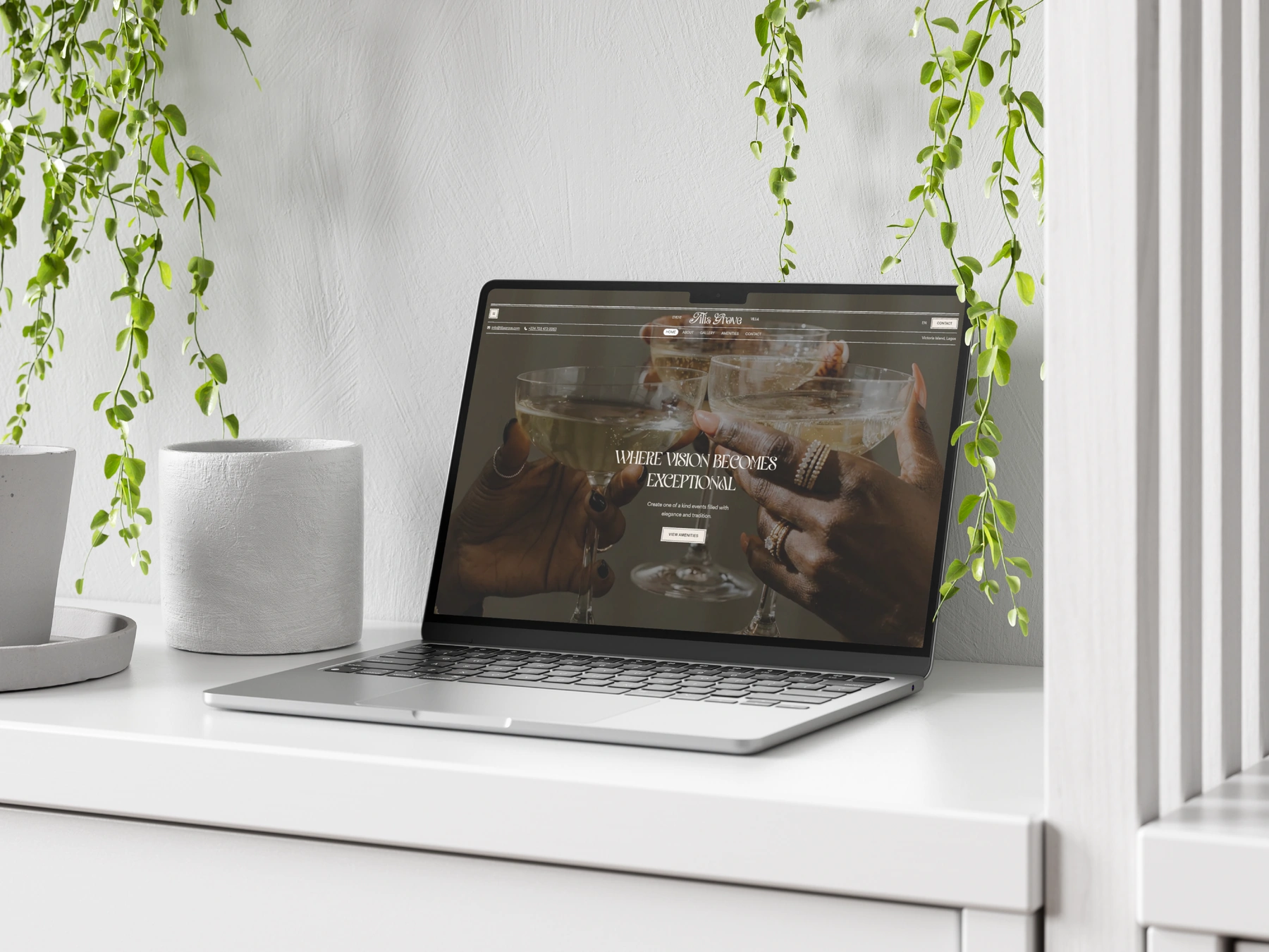 A laptop on a white shelf displaying the Tilia Grove website homepage, framed by trailing green plants.